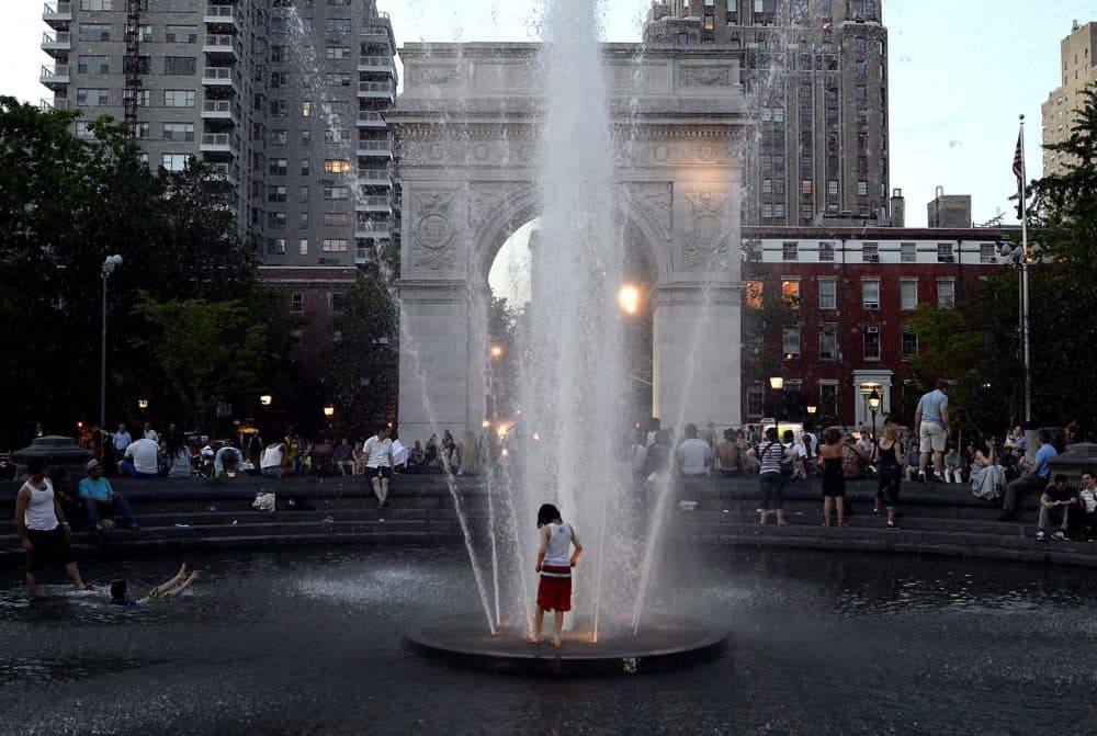 Kids take advantage of the hot weather as they play in the fountain at dusk at Washington Square Park on May 31, 2013. (Timothy Clary/AFP via Getty Images)