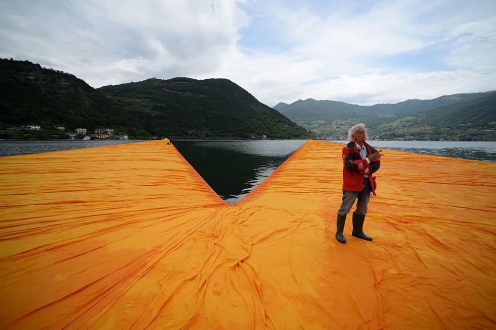 Artist Christo Vladimirov Javacheff walks on his monumental installation "The Floating Piers" he created with late Jeanne-Claude, on June 16, 2016, during a press preview at the lake Iseo, northern Italy. Some 200,000 floating cubes create a 3-kilometers runway connecting the village of Sulzano to the small island of Monte Isola on the Iseo Lake for a 16-day outdoor installation opening on June 18. (Filippo Monteforte/AFP/Getty Images)