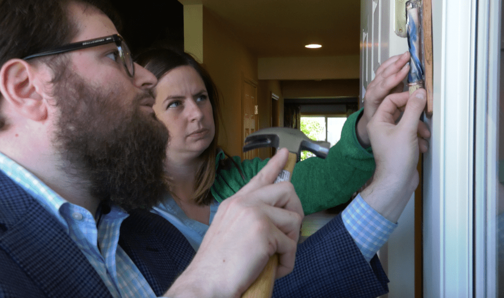Rabbi Chaim Bruk and his wife Chavie Bruk hanging a mezuzah. (Courtesy Gerald Peary and Amy Geller)