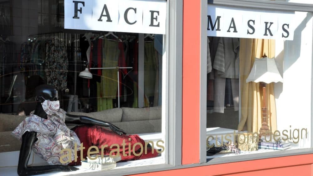 An alteration shop advertising face masks for sale in downtown Westerly, R.I., is pictured here. (Alex Nunes/The Public's Radio)