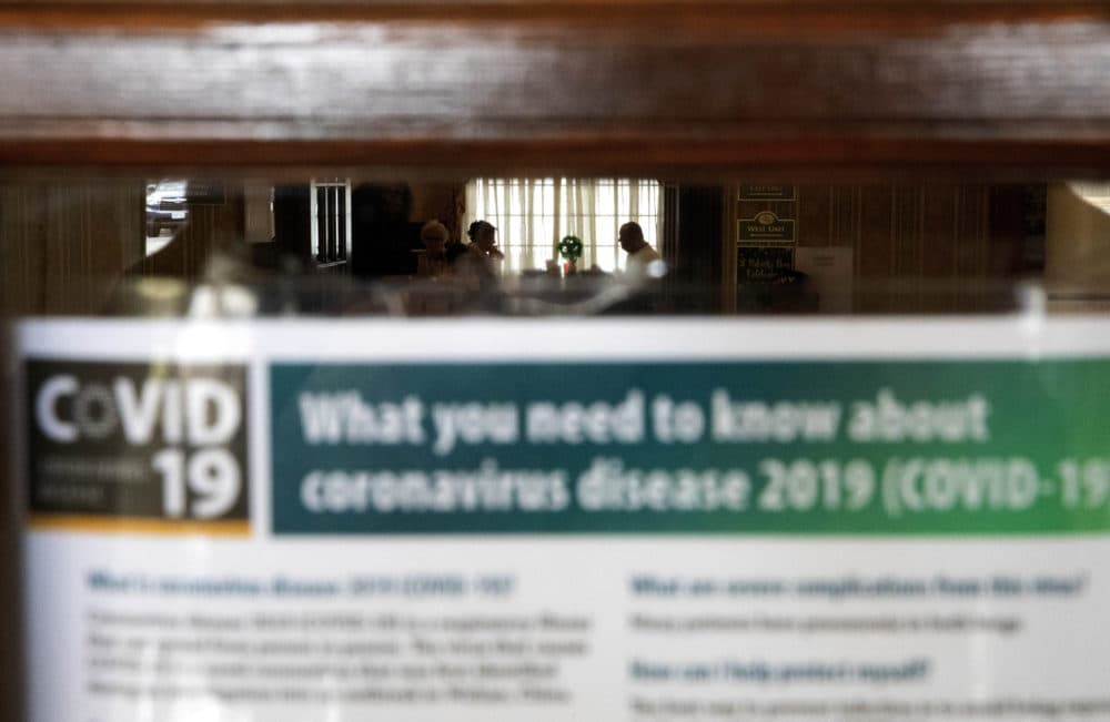 An information sheet on the new coronavirus is posted in the lobby of the South Shore Rehabilitation and Skilled Care Center on March 6 in Rockland, Mass. (David Goldman/AP)
