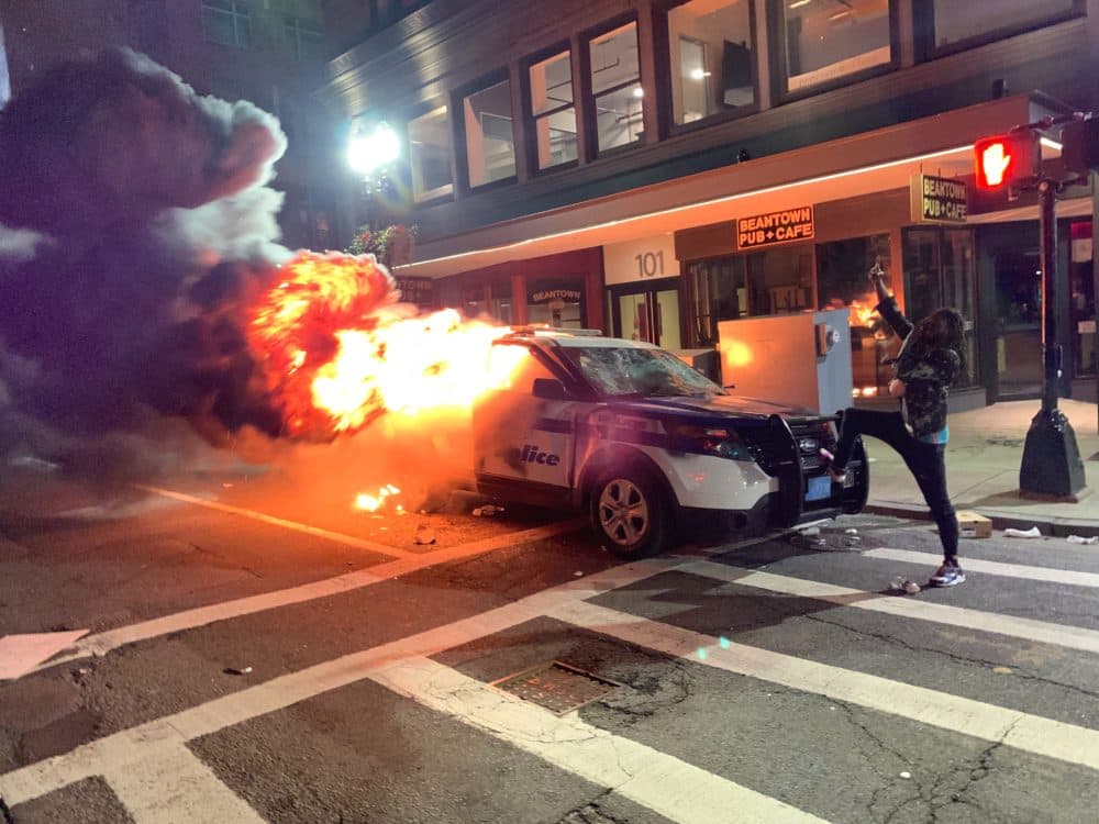 A police car on fire on Tremont Street Sunday. (Jesse Costa/WBUR)
