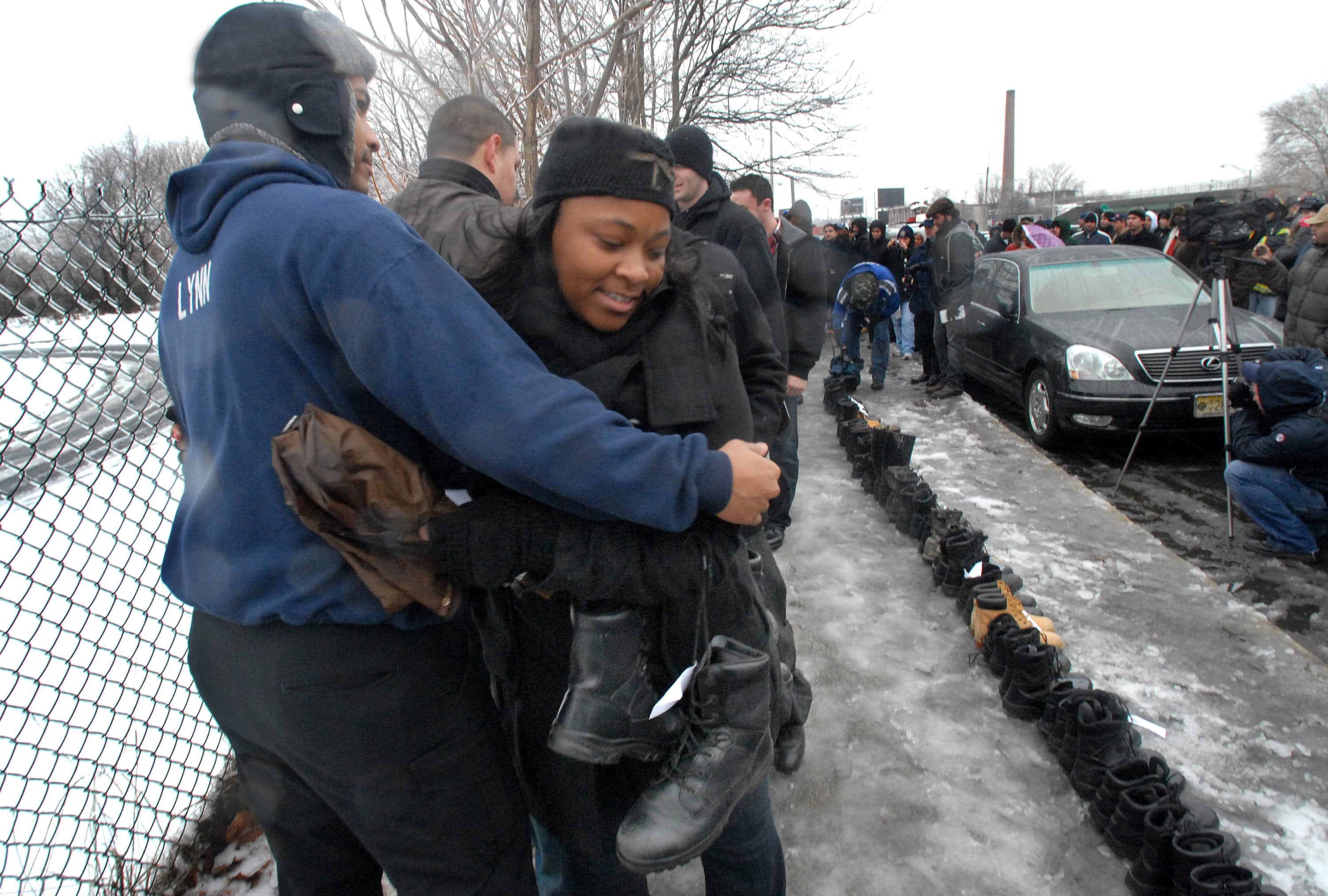 Tya Miles, who'd only been a Camden cop for a year, prepares to lay her boots in a row with those of laid off co-workers on Januaray 18, 2011. (Photo by April Saul)