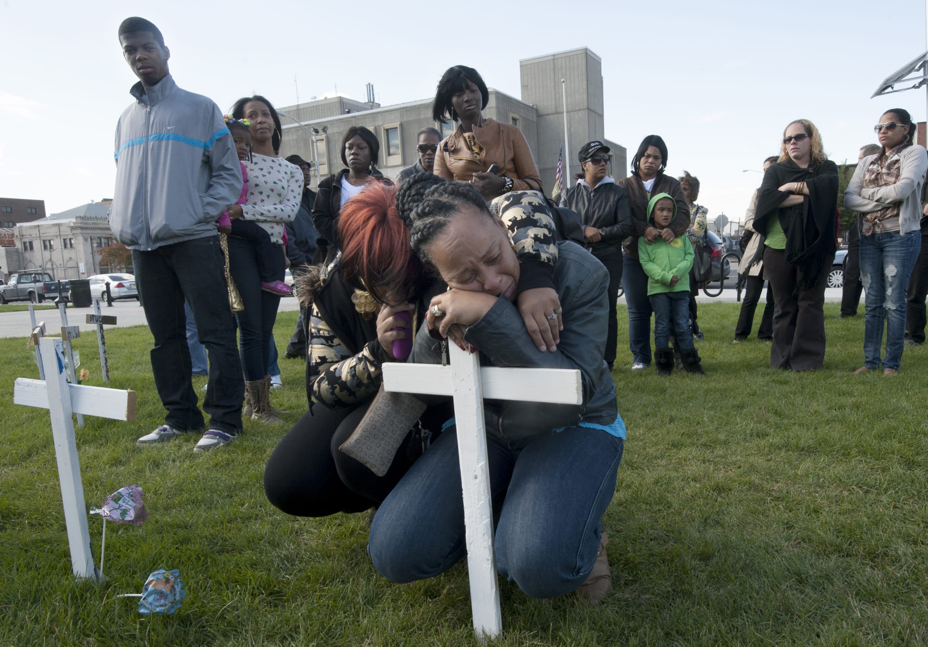 On Oct. 16, 2012, Lisa Anderson wept after a cross in memory of her son, Lateaf Anderson, was placed in a field commemorating that year's homicide victims in Camden in front of City Hall. (Photo by April Saul)