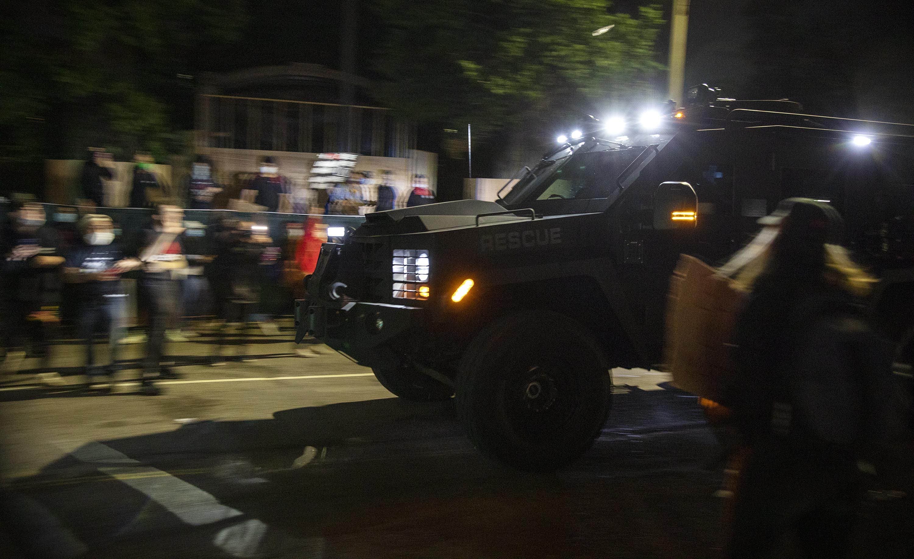 An armored police vehicle drove past the State House as protesters dispersed on May 31. (Robin Lubbock/WBUR)