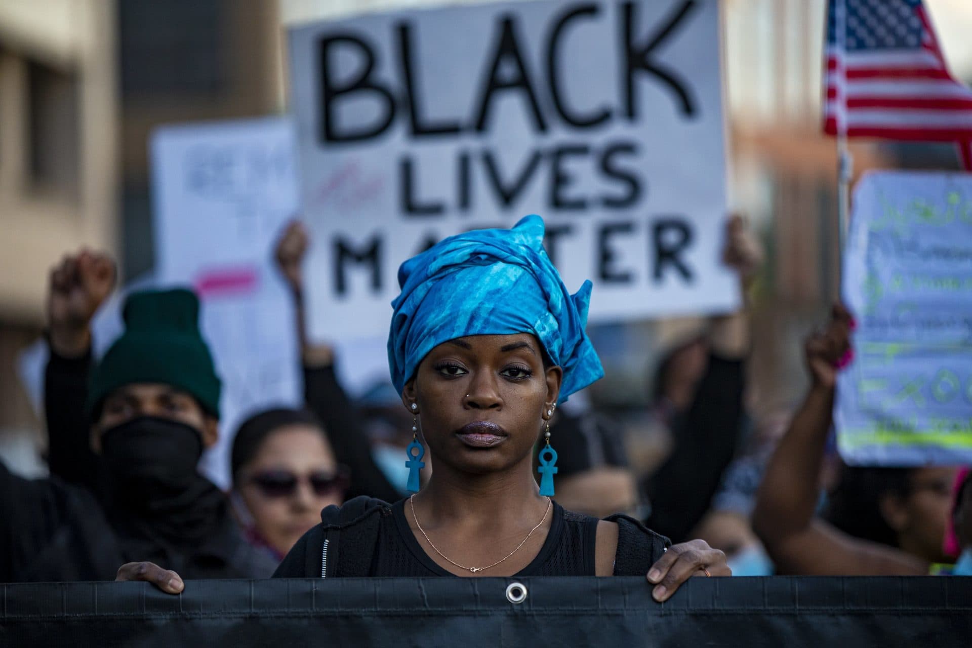 A woman holds a banner during the protest Sunday in Boston. (Jesse Costa/WBUR)