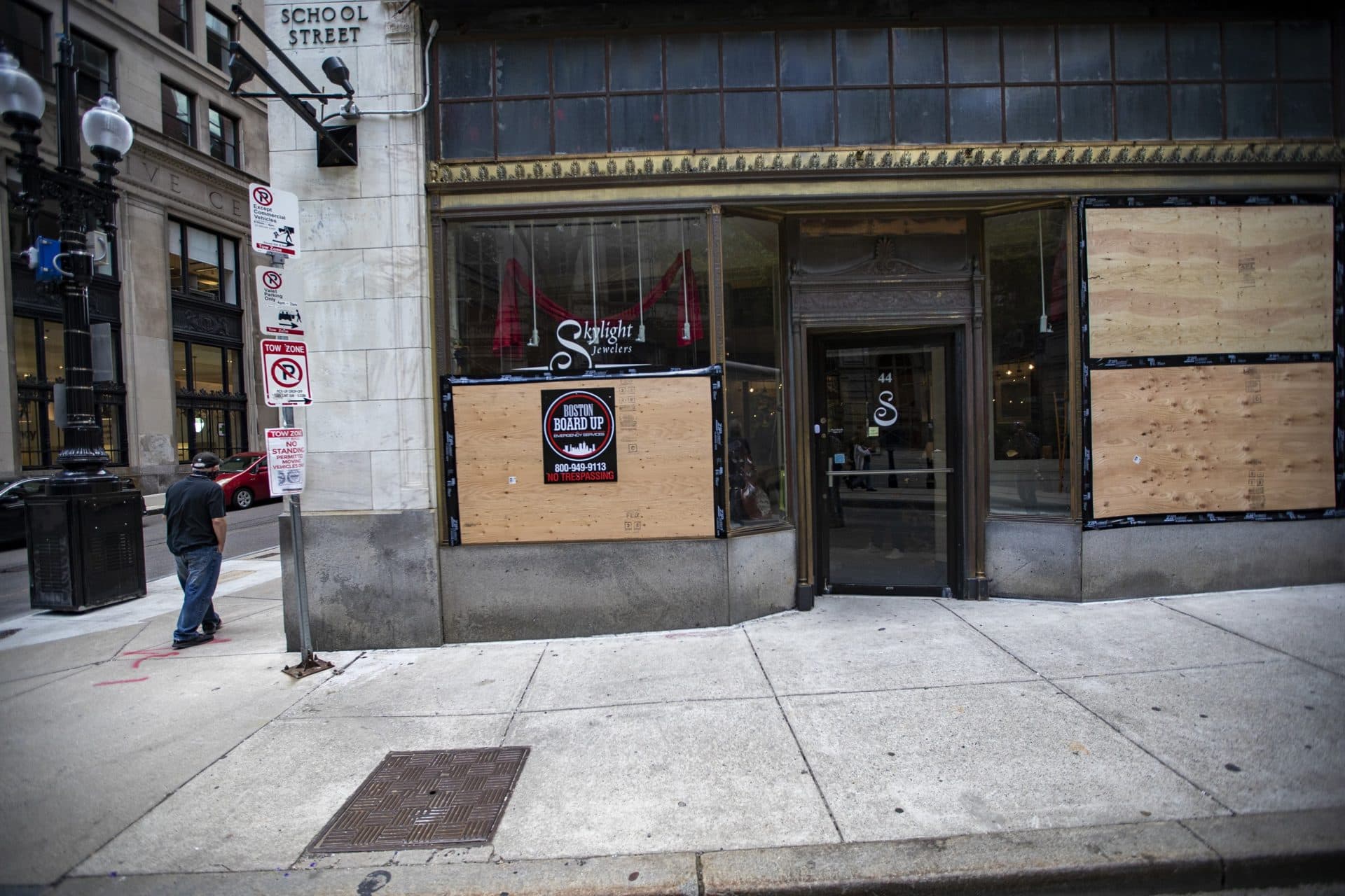 The windows of Skylight Jewelers, one of the businesses on School Street that were looted after the protest, were boarded up. (Jesse Costa/WBUR)