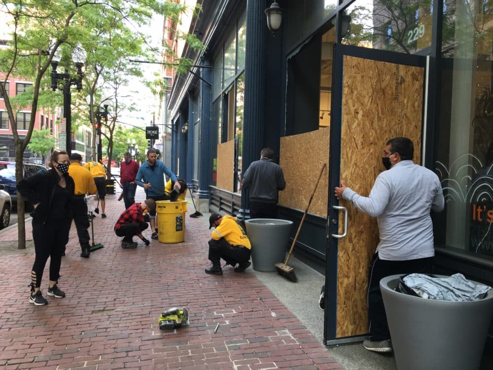 Providence city workers and citizens cleaned up businesses on Westminster Street Tuesday morning. (Sofia Rudin/The Public's Radio)