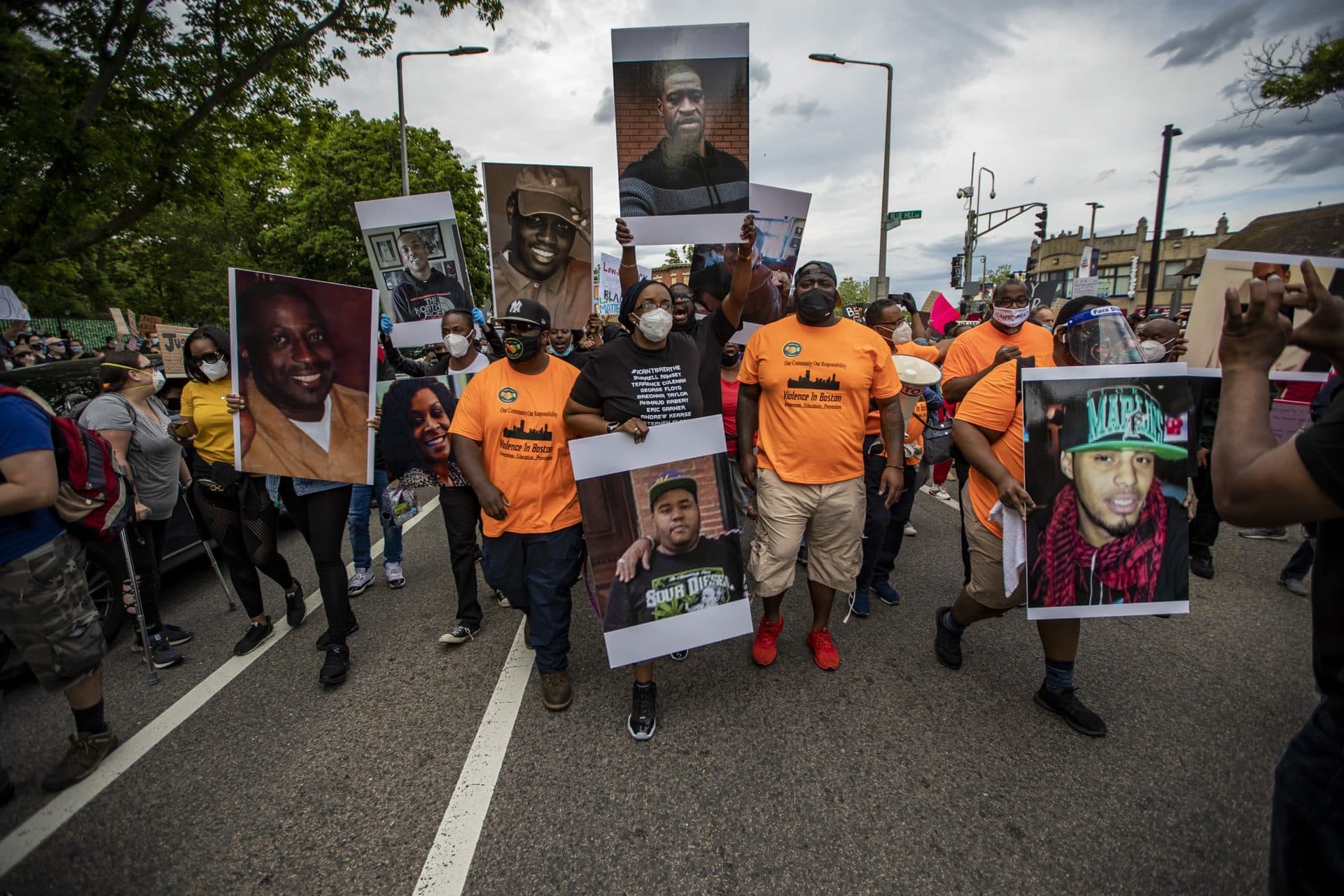 Monica Cannon-Grant (center) leads the march down Franklin Park Road in Roxbury. (Jesse Costa/WBUR)