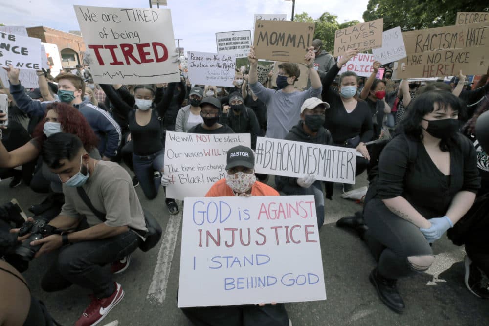 People kneel during a protest in Boston, Tuesday, June 2, 2020, to demonstrate against police brutality following the death of George Floyd. (Charles Krupa/AP)