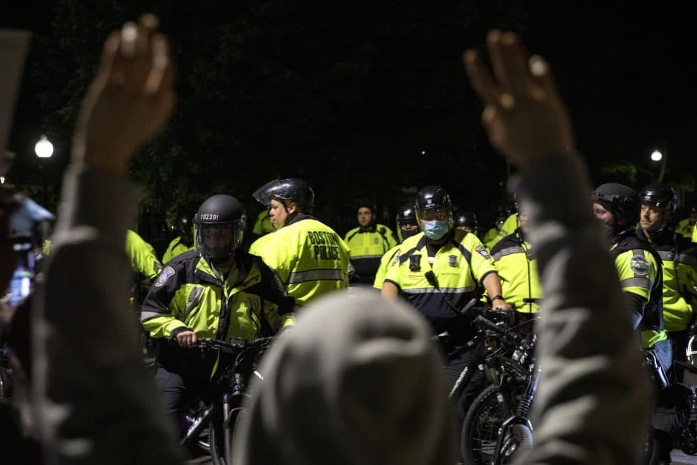 Protesters coming down Beacon Street on Tuesday find the road blocked by bicycle police . (Robin Lubbock/WBUR)