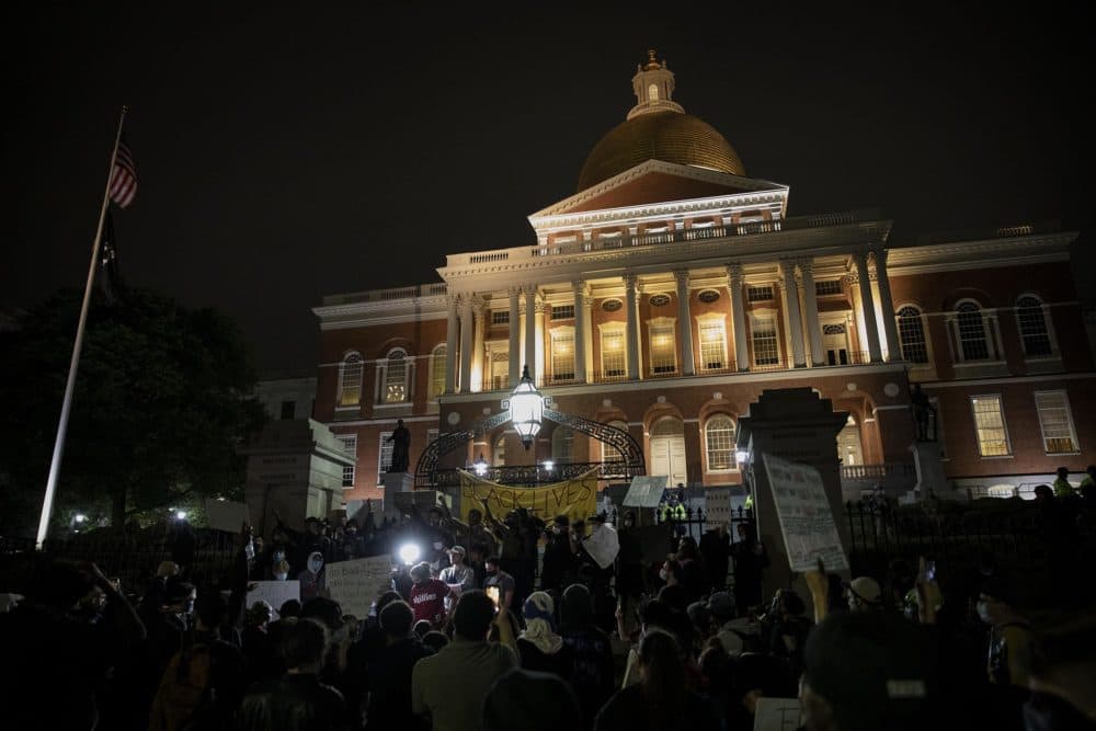 After 11 p.m. a group of protesters continue the protest that began in Franklin Park, outside the State House. (Robin Lubbock/WBUR)