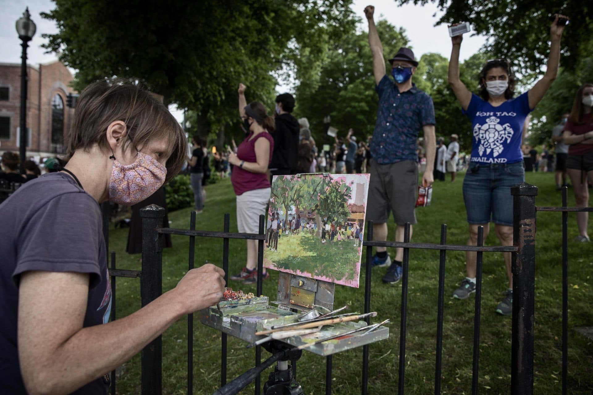 Artist Wendi Gray paints the scene at the Vigil For Black Lives at Adams Park in Roslindale. (Robin Lubbock/WBUR)