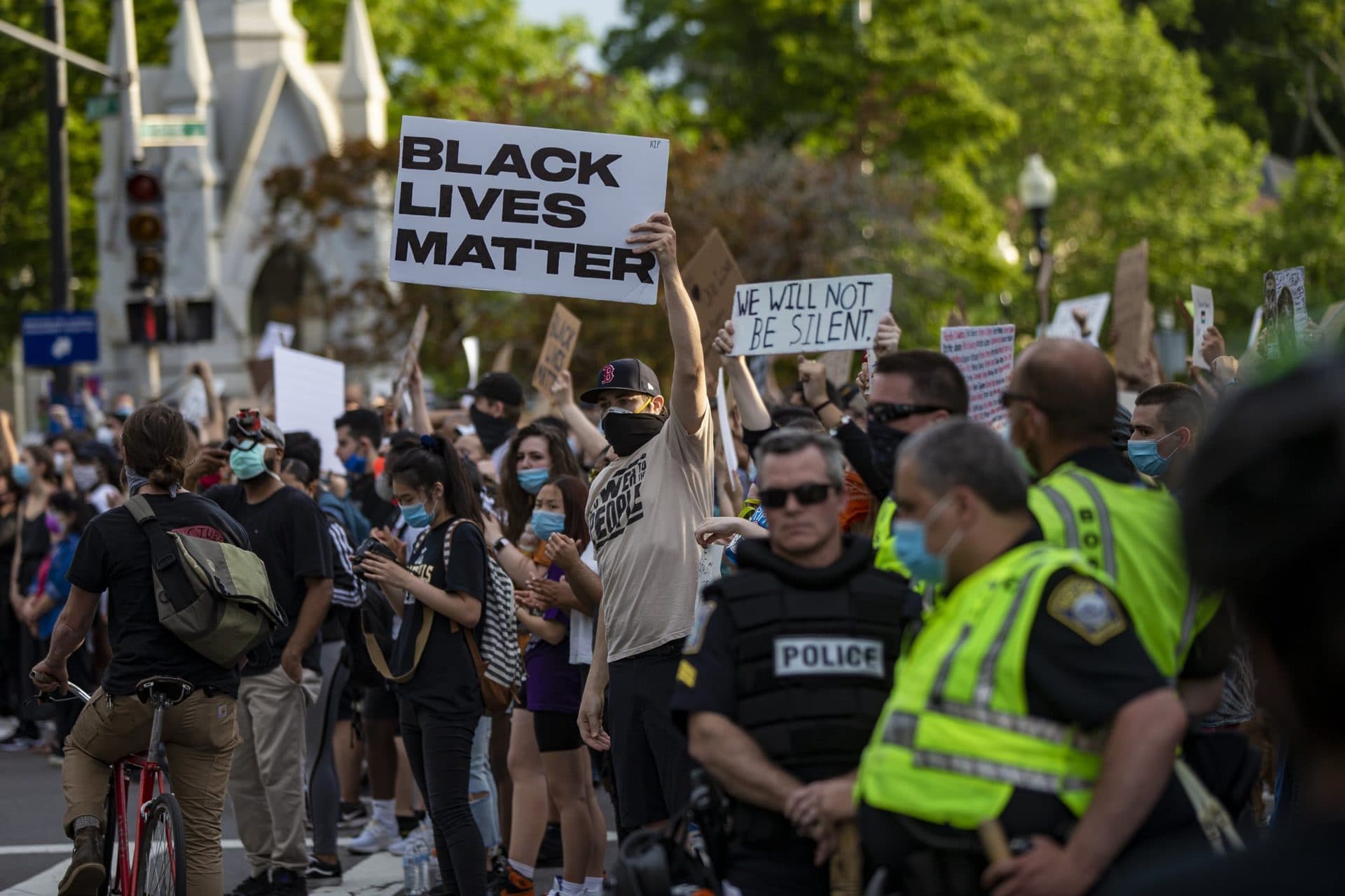 Police stand by and watch as hundreds of protesters gather at the Soldier’s Memorial in Jamaica Plain for the Black Lives Matter rally. (Jesse Costa/WBUR)