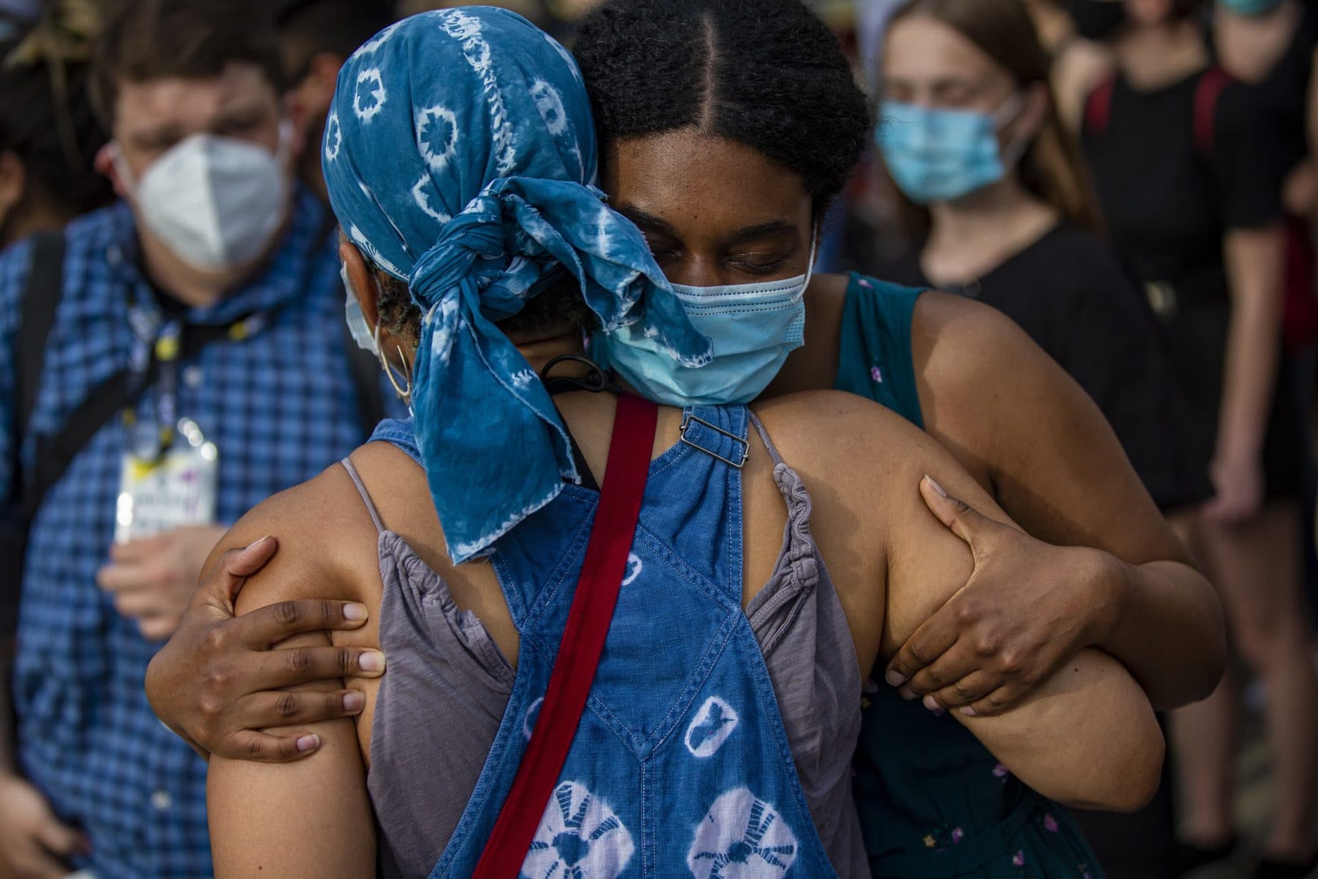 Two women embrace during a vigil for George Floyd in Jamaica Plain. (Jesse Costa/WBUR)