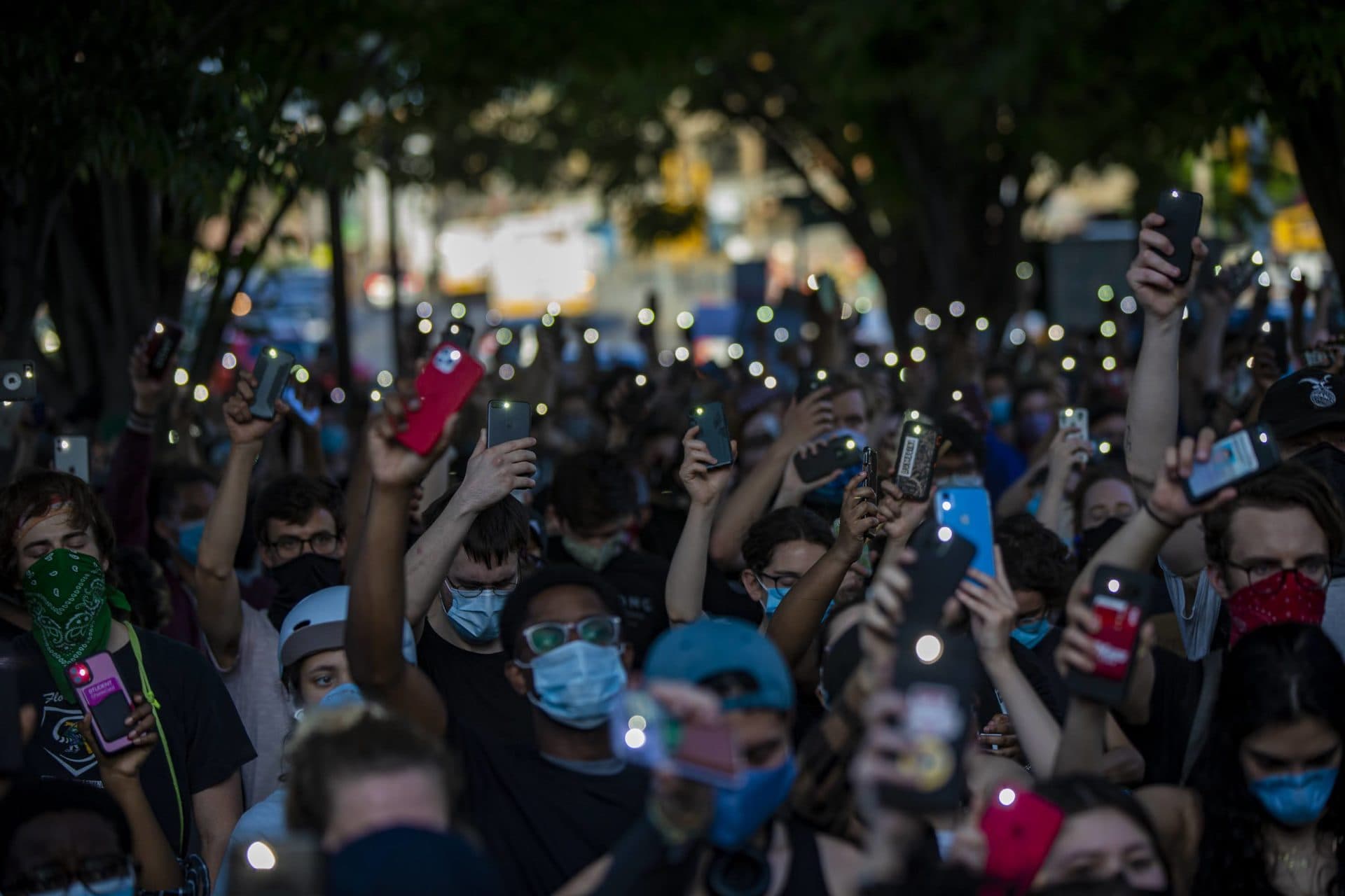 Protesters held up their cellphones, flashlights illuminated, at a vigil for Breonna Taylor. (Jesse Costa/WBUR)