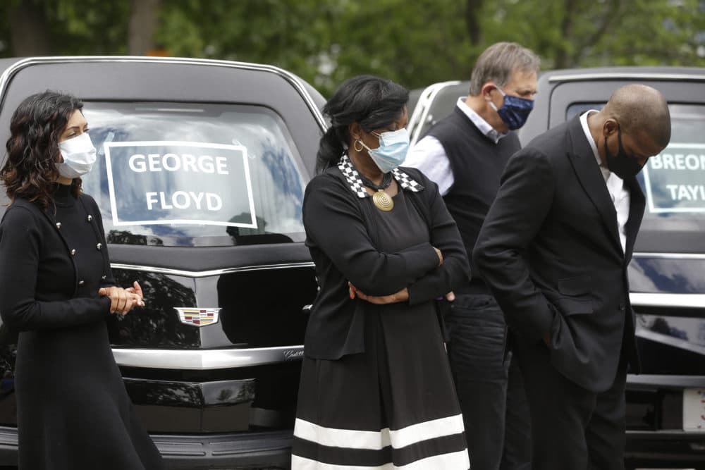 People pray Sunday, June 7, 2020, before taking part in a procession of vehicles, including three hearses meant to honor fallen George Floyd, Breonna Taylor, and Ahmaud Arbery, through Boston neighborhoods. The hearses were part of what organizers are calling #BostonBlackMemorial Funeral Procession. (Steven Senne/AP)