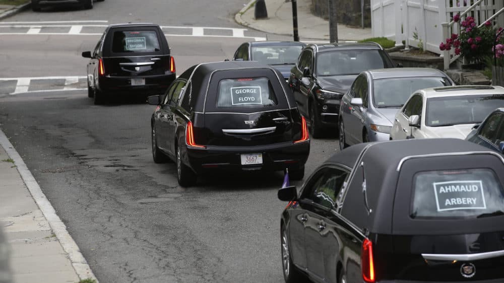 A procession of vehicles, including three hearses, meant to honor George Floyd, Breonna Taylor, and Ahmaud Arbery makes its way through Boston neighborhoods. (Steven Senne/AP)