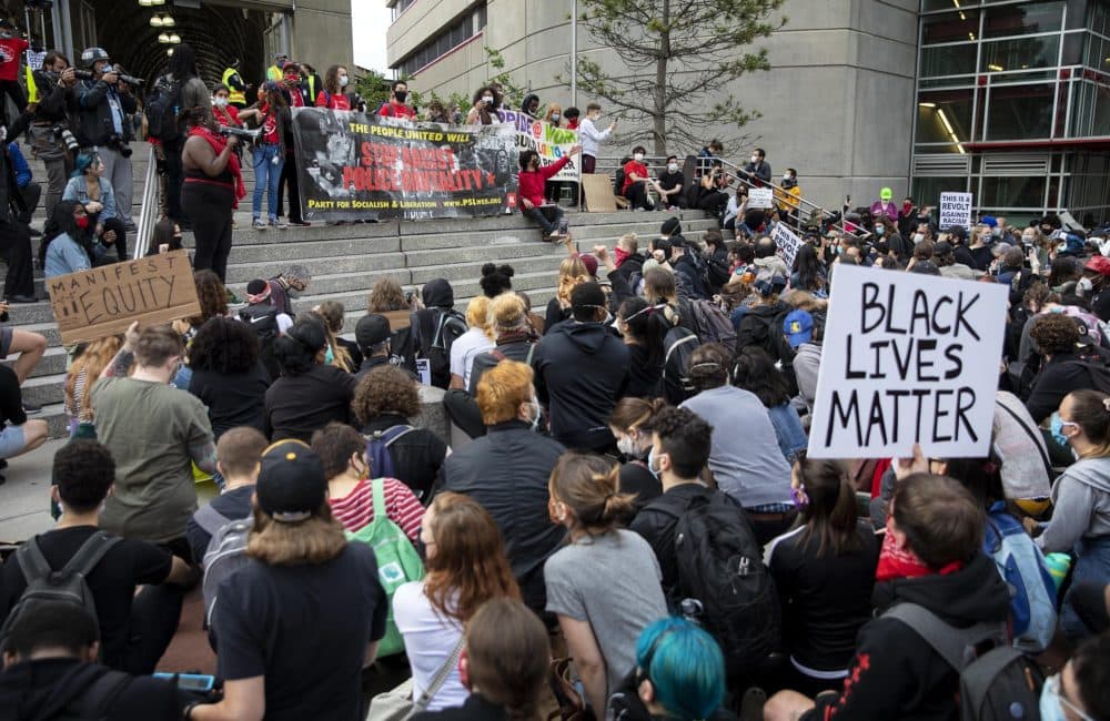 Organizers address the marchers on the steps of Ruggles Station. (Robin Lubbock/WBUR)