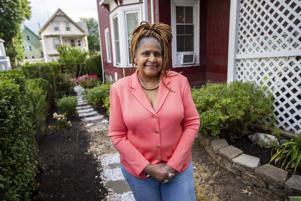 Dorothy Williams standing behind her home where she runs a day care in Dorchester. (Jesse Costa/WBUR)
