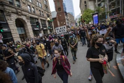 Hundreds of protesters march up Washington Street past the Old South Meeting House en route to Boston City Hall during the F.T.P. March to Defund Police and Fund Our Communities. (Jesse Costa/WBUR)