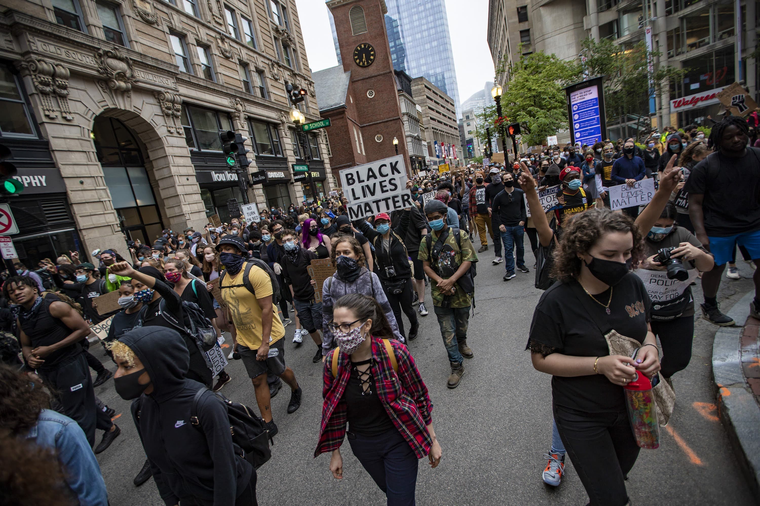 Hundrreds of protesters  march up Washington Street past the Old South Meeting House en route to Boston City Hall during the F.T.P. March to Defund Police and Fund Our Communities. (Jesse Costa/WBUR)