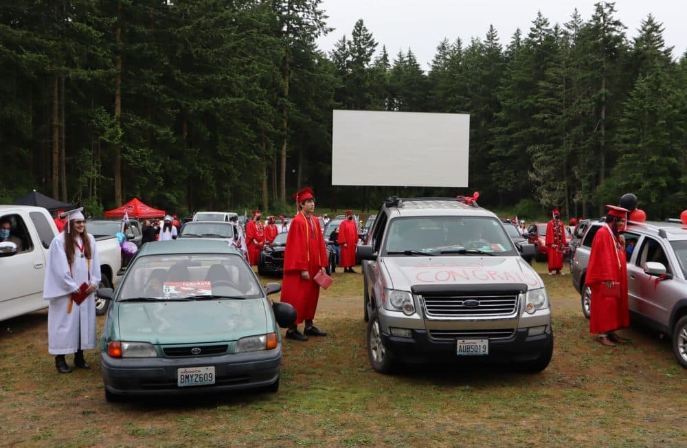 Port Townsend High School seniors stepped outside their vehicles to receive their diplomas during the 2020 graduation ceremony held at the local drive-in movie theater. (Tom Banse/Northwest News Network)