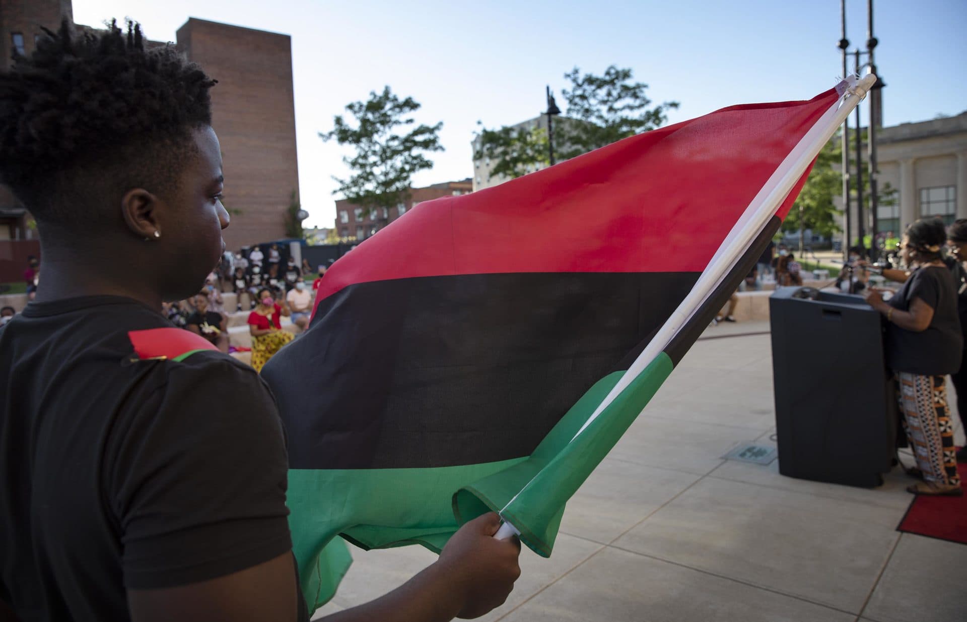 The colors of the Pan-African flag, symbolizing the blood, the people and the land, fly at the Juneteenth gathering in Brockton. (Robin Lubbock/WBUR)