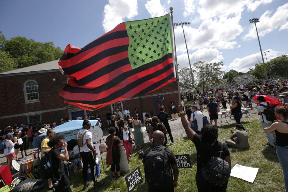 A stylized American Black Lives Matter flag flies during a Juneteenth rally in Boston. (Michael Dwyer/AP)