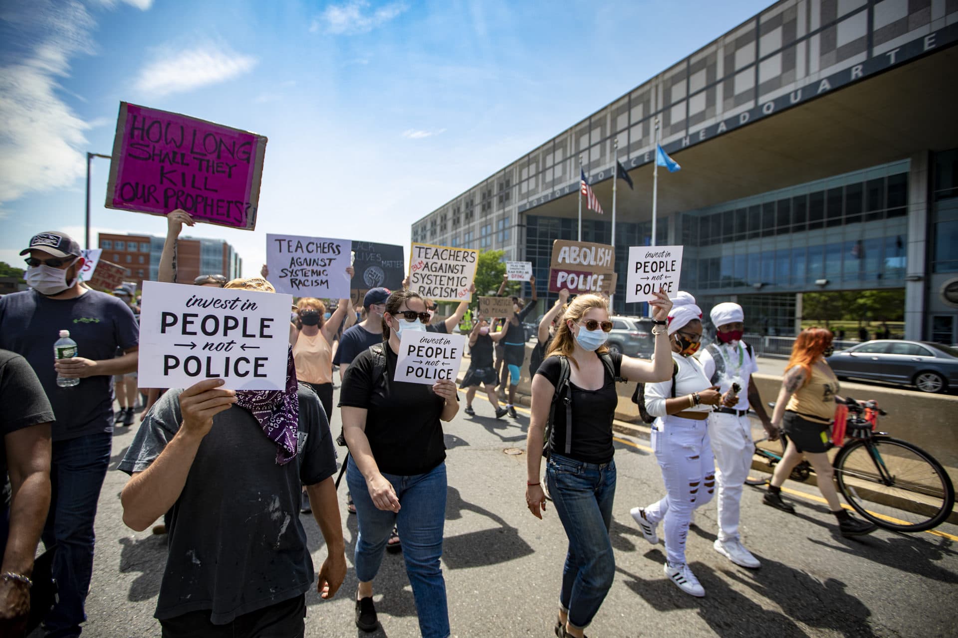 Protesters march past the Boston Police Headquarters. (Jesse Costa/WBUR)