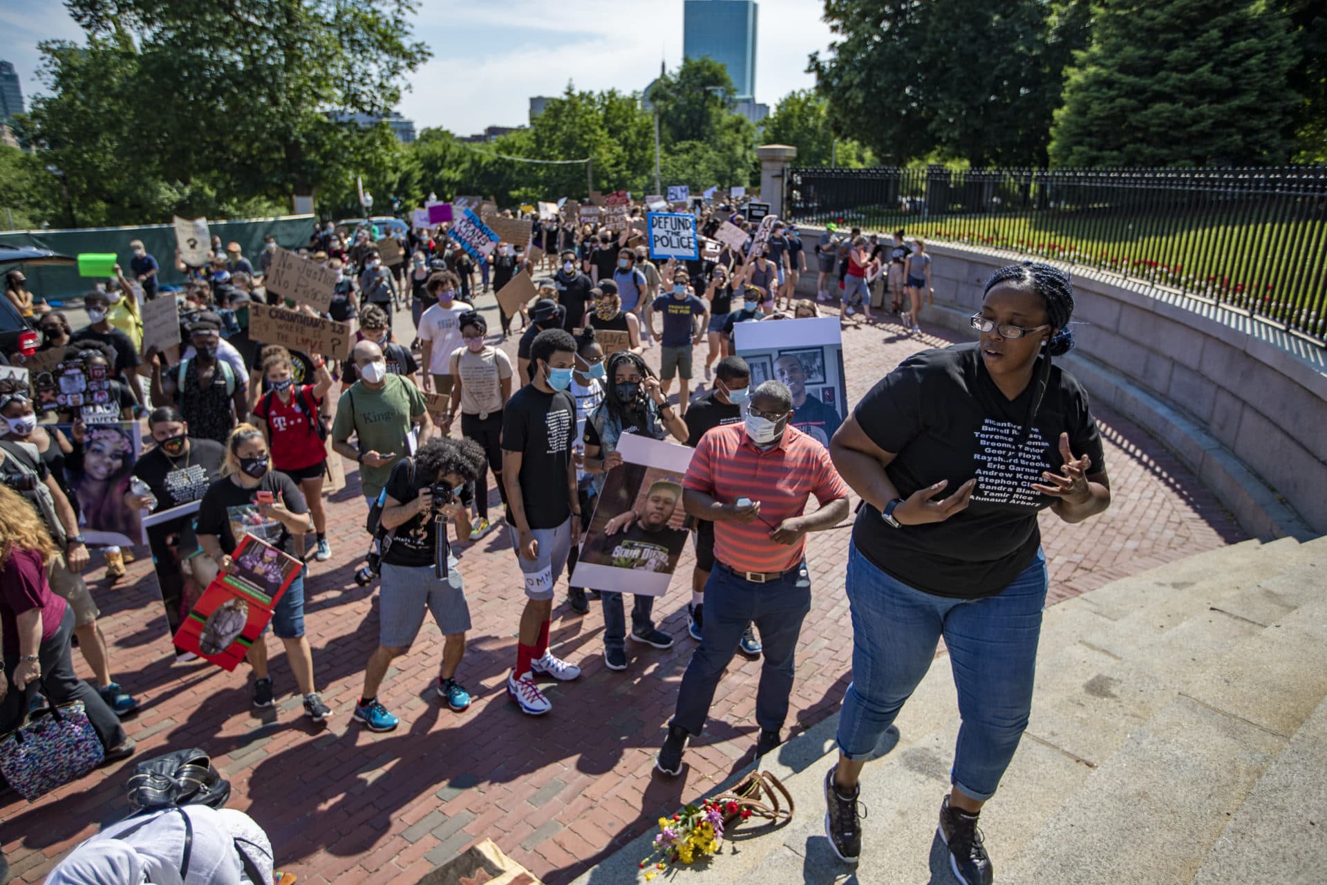 March organizer Monica Cannon-Grant climbs the steps of the State House gates. (Jesse Costa/WBUR)