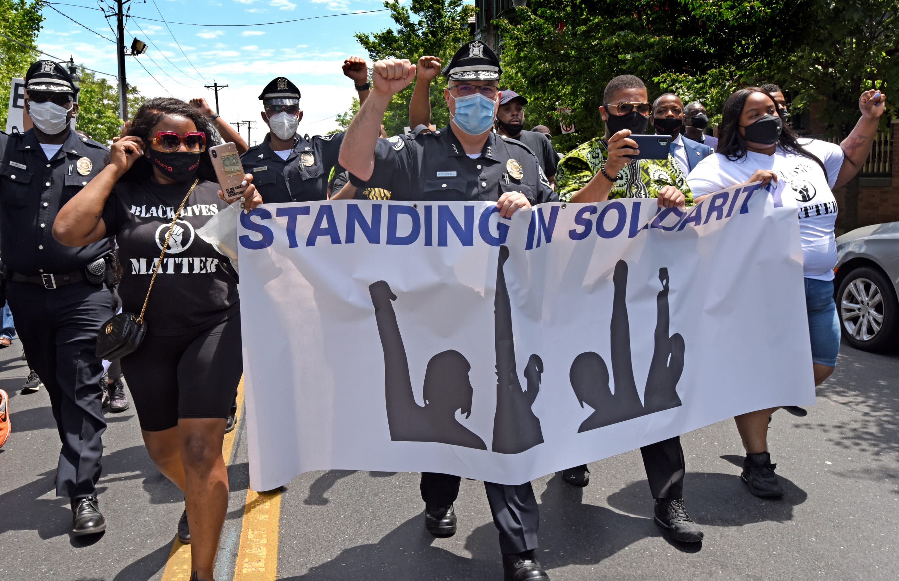 On May 30, 2020, Camden County Metro Police Chief Joe Wysocki raises a fist while marching with Camden residents and activists to protest the killing of George Floyd in Minneapolis. (Photo by April Saul)