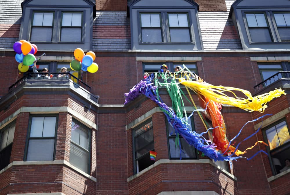 Spectators watch from balconies along the route of the Gay Pride Parade, Saturday, June 8, 2019, in Boston. (Elise Amendola/AP)