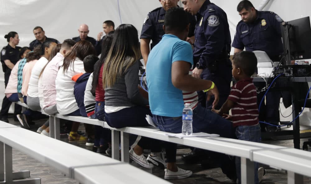 In this Sept. 17, 2019, file photo, migrants who are applying for asylum in the United States go through a processing area at a new tent courtroom at the Migration Protection Protocols Immigration Hearing Facility in Laredo, Texas. (Eric Gay/AP)