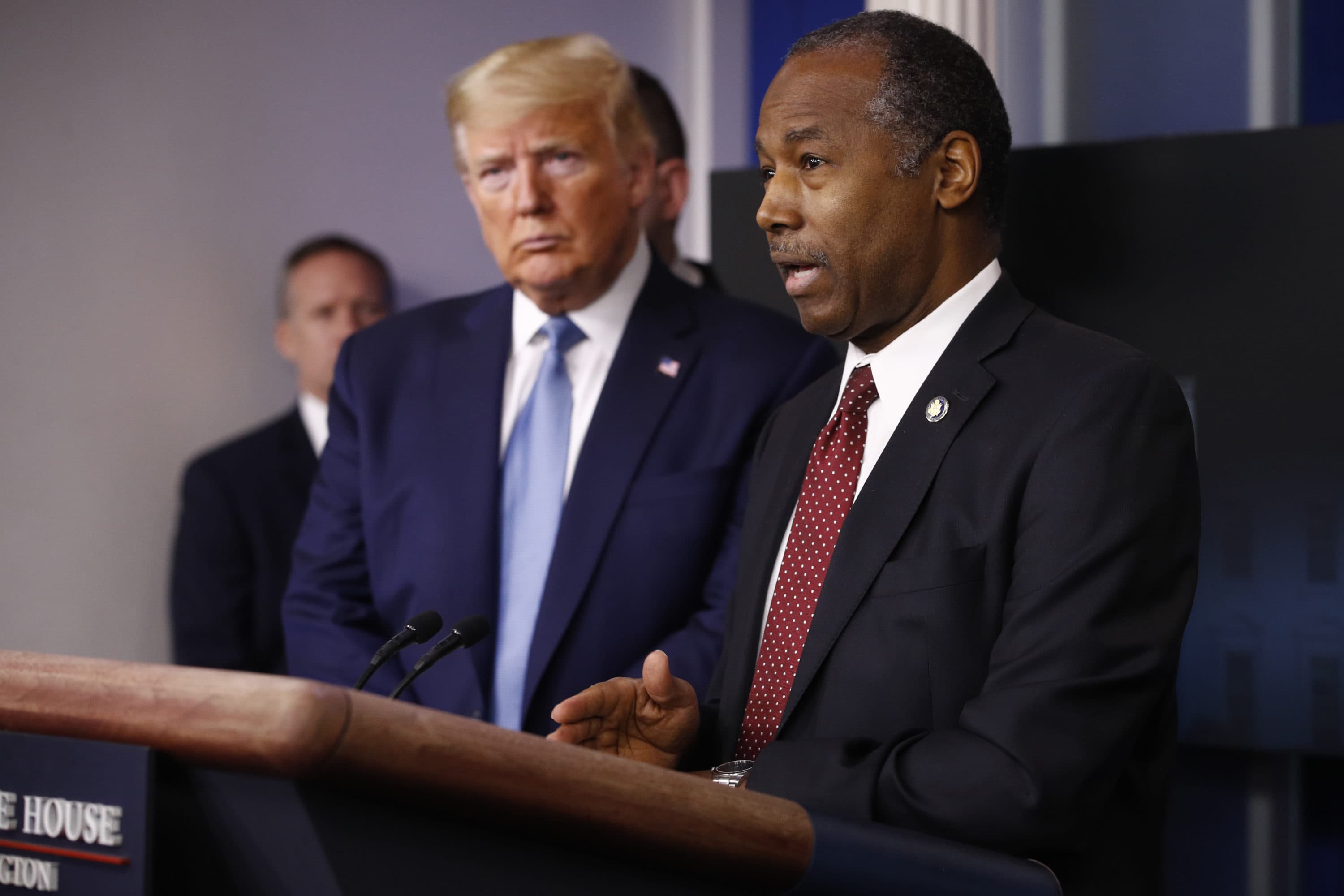 President Trump listens as Housing and Urban Development Secretary Ben Carson speak during a coronavirus task force briefing in March. (Patrick Semansky/AP)