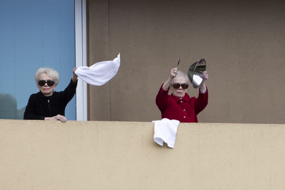 Residents of Vi at La Jolla retirement complex dance and make noise from their balconies, Wednesday, April 8, 2020, in San Diego. (Gregory Bull/AP)