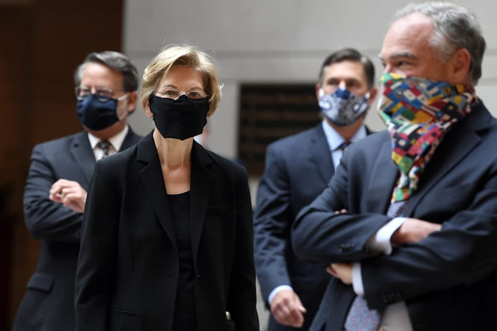 Sen. Elizabeth Warren, joined by Sen. Gary Peters., D-Mich., left, Sen. Martin Heinrich, D-N.M., second from right, and Sen. Tim Kaine, D-Va., right, prepare for an 8 minutes and 46 second pause on Capitol Hill in Washington on Thursday, June 4, to commemorate the life of George Floyd. (AP Photo/Susan Walsh)