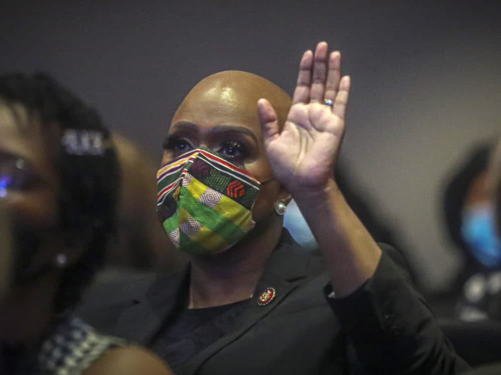 U.S. Rep. Ayanna Pressley of Massachusetts raises her hand during a memorial service for George Floyd at North Central University, on Thursday, June 4, 2020, in Minneapolis. (AP Photo/Bebeto Matthews)