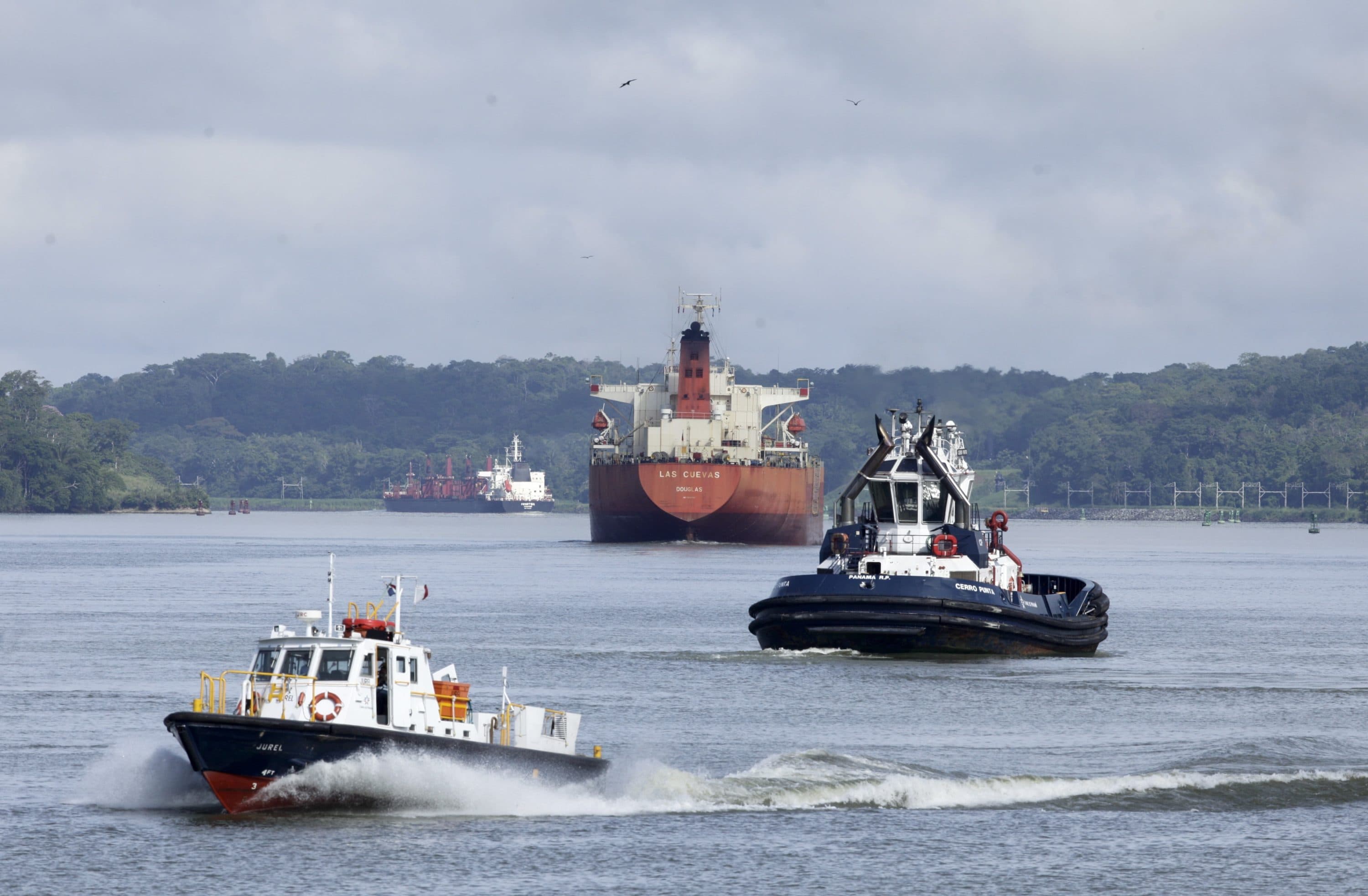 Cargo ships navigate Panama Canal waters in Gamboa, Panama, Wednesday, June 17, 2020. The Panama Canal began to feel the first adverse effects of the coronavirus pandemic on its business after registering a drop in its ship transits while applying rigorous measures to prevent further contagion among its workers. (Arnulfo Franco/AP)