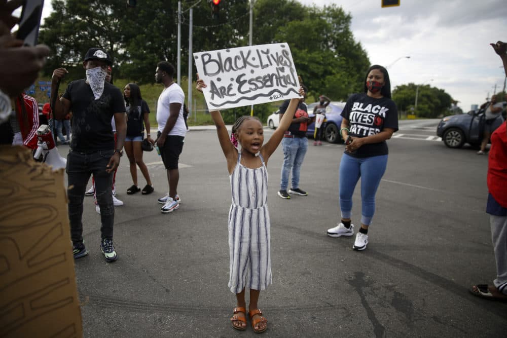 A young protester yells &quot;Black Lives Matter&quot; in the street near a Wendy's restaurant on Wednesday, June 17, 2020 in Atlanta. The restaurant was where Rayshard Brooks was shot and killed by police. (AP Photo/Brynn Anderson)