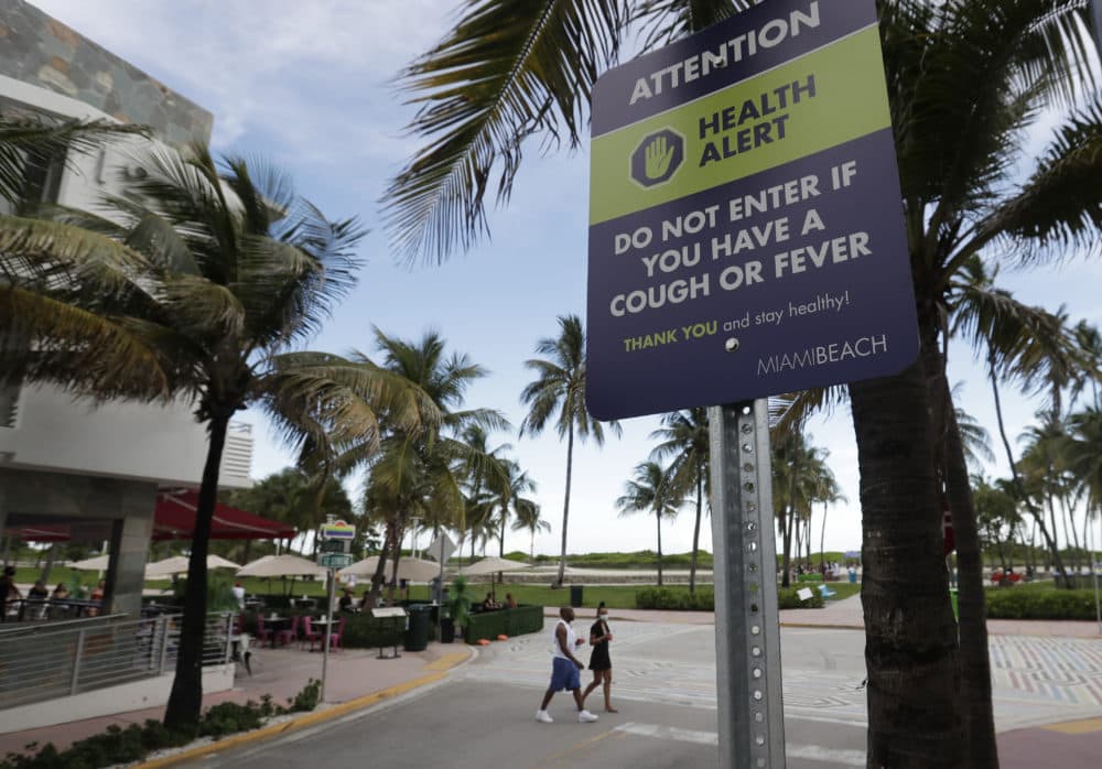 A sign asks people not to visit Miami Beach if they have a cough or fever, Monday, June 22, 2020. (Wilfredo Lee/AP)