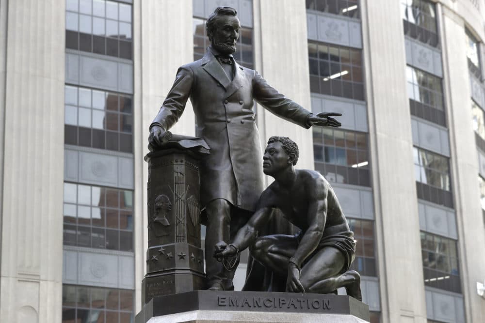A statue that depicts a freed enslaved man kneeling at Abraham Lincoln's feet rests on a pedestal, Thursday, June 25, 2020, in Boston. The statue in Boston is a copy of the Emancipation Memorial, also known as the Emancipation Group and the Freedman's Memorial, that was erected in Lincoln Park, in Washington, D.C., in 1876. Three years later, the copy was installed in Boston. Calls are mounting for the removal of both statues. (Steven Senne/AP)