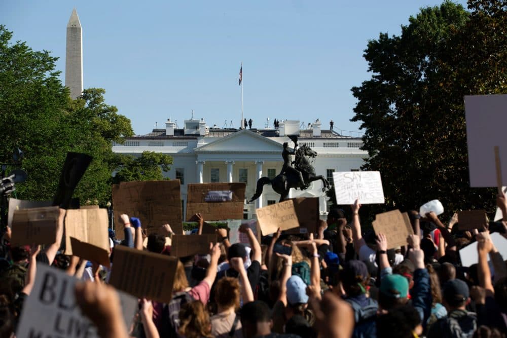 Demonstrators hold up placards protest outside of the White House, over the death of George Floyd in Washington D.C. on June 1, 2020. (JOSE LUIS MAGANA/AFP via Getty Images)