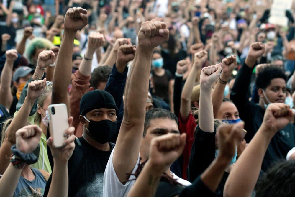 Demonstrators raise their fists in a sign of solidarity while protesting the death of George Floyd, an unarmed black man who died while while being arrested and pinned to the ground by the knee of a Minneapolis police officer, at the Colorado State Capital in Denver, Colorado on June 3, 2020. (Jason Connolly/AFP)