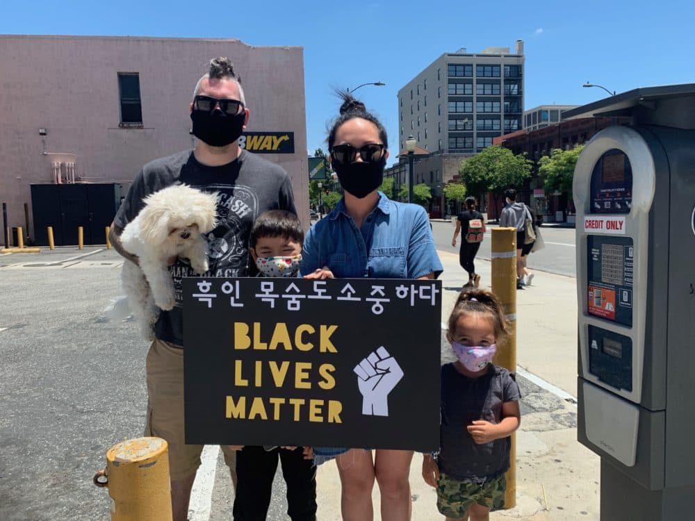 Pasadena residents Robert and Caroline Bowling with their children at a protest this weekend. (Tonya Mosley, Here & Now)