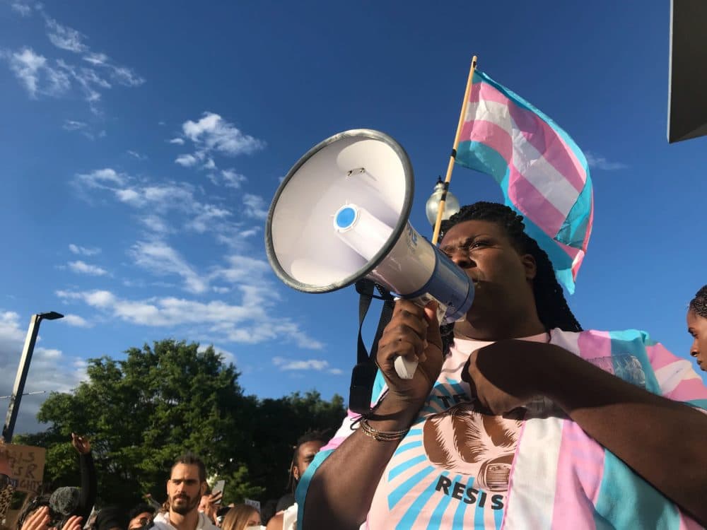 Athena Vaughn, with the Massachusetts Transgender Political Coalition, speaks through a bullhorn to the crowd at the &quot;Trans Resistance Rally and March&quot; Saturday. (Quincy Walters/WBUR)