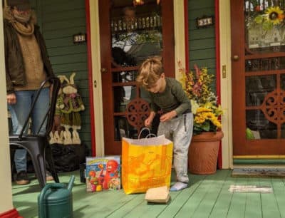 A child receives a personalized care package delivery from the “It Takes a Village” campaign. (Photo: Henry Bear's Park)