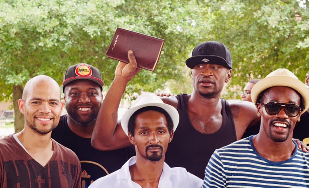 George Floyd holds up a Bible. (Resurrection Houston/Nijalon Dunn)