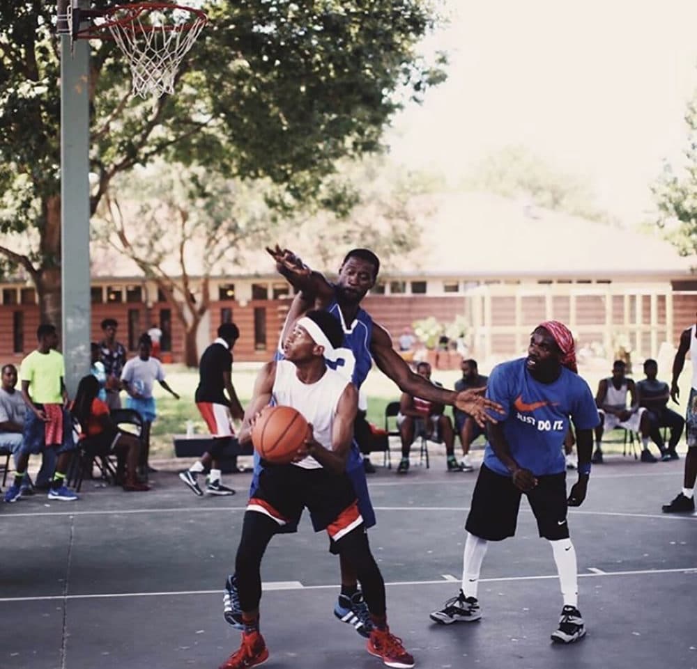 George Floyd, in the blue jersey, playing basketball. George Floyd holds up a Bible. (Resurrection Houston/Nijalon Dunn)