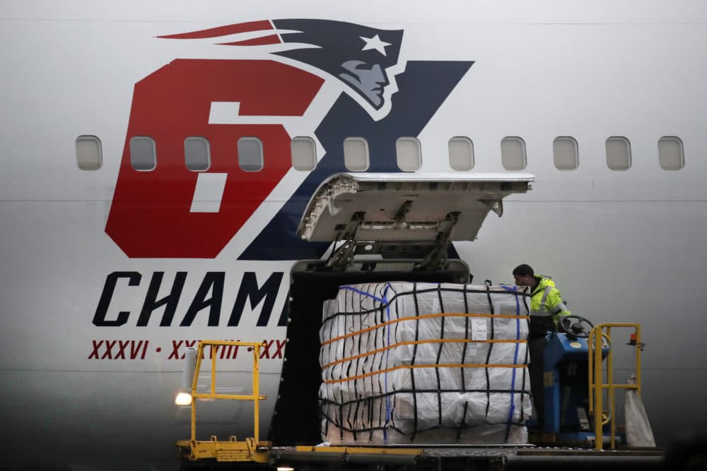 Palettes of N95 respirator masks are off-loaded from the New England Patriots football team's customized Boeing 767 jet on the tarmac on April 2 at Logan Airport in Boston, after returning from China. (Elise Amendola/AP)